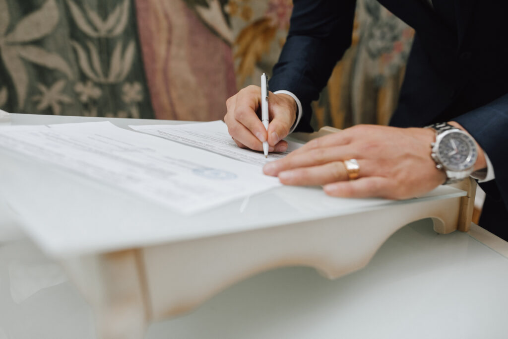 man with a pen signs a document